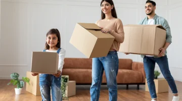 happy-young-arab-family-carrying-boxes-in-new-flat